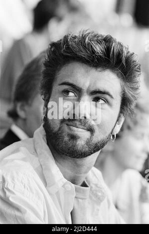 Live Aid dual venue benefit concert held on 13th July 1985 at Wembley Stadium in London, England, and the John F. Kennedy Stadium in Philadelphia, Pennsylvania, United States. The concerts were organised as a follow up to the Band Aid single 'Do They Know Its Christmas?'  to raise money for victims of the famine in Ethiopia. Picture shows  George Michael watching  the concert at Wembley. Stock Photo