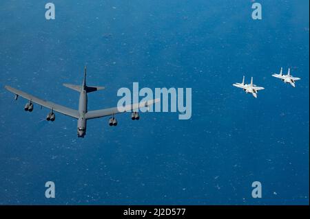 A U.S. Air Force B-52H Stratofortress flies alongside Qatar Emiri Air Force F-15QAs over the Arabian Gulf, March 29, 2022. The bomber’s flight originated at Royal Air Force Fairford, England, and flew over the East Mediterranean, Arabian Peninsula, and Red Sea before departing the region. U.S. Air Force photo by Staff Sgt. Jerreht Harris) Stock Photo