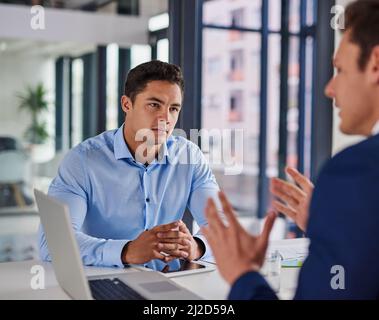 Focused on getting some serious business done. Shot of two businessmen having a meeting in an office. Stock Photo