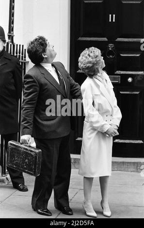 Chancellor of the Exchequer Nigel Lawson and his wife Therese look up at their children outside 11 Downing Street. 19th March 1985. Stock Photo