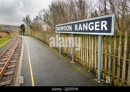 Snowdonia,Wales,UK-March 17th 2022:The railway platform sign,stands prominently at the small,empty,Welsh mountain train halt,on the route through Snow Stock Photo