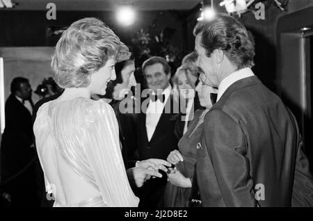 HRH The Princess of Wales, Princess Diana talking with lead actor Roger Moore at The Royal Premiere of the 14th 007 James Bond Movie, "A View To A Kill"  at the Odeon Cinema, Leicester Square, London. This was Roger Moore's last of seven Bond Films. His first "Live and Let Die", was released in 1973.  Princess Diana wears a stunning silver Bruce Oldfield dress.   In the background is actor Patrick Macnee, who plays Sir Godfrey Tibbett in the film.  Picture taken 14th June 1985 Stock Photo