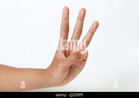 An adult female hand showing three fingers or the number three isolated on a white background Stock Photo