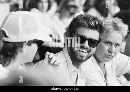 Live Aid dual venue benefit concert held on 13th July 1985 at Wembley Stadium in London, England, and the John F. Kennedy Stadium in Philadelphia, Pennsylvania, United States. The concerts were organised as a follow up to the Band Aid single 'Do They Know Its Christmas?'  to raise money for victims of the famine in Ethiopia. Picture shows  George Michael and Elton John watching  the concert at Wembley. Stock Photo