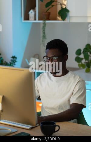 Thoughtful web developer work on computer, programmer trying to find solution for bug in app code Stock Photo