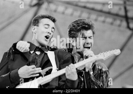 Wham ! The Farewell Concert at Wembley Stadium, London on 28th June 1986. George Michael's real name is Georgios Kyriacos Panayiotou  Wham !,  (singer George Michael, and singer/guitarist Andrew Ridgeley) played their final concert as Wham !, although Andrew joined George as a guest on a few later George Michael solo shows.  Picture taken 28th June 1986 Stock Photo