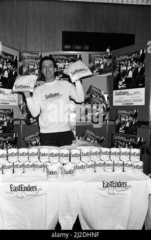 'Dirty Den' aka Leslie Grantham, landlord of the Queen Victoria had a part time job selling EastEnders t-shirts and coffee mugs. 29th November 1985. Stock Photo