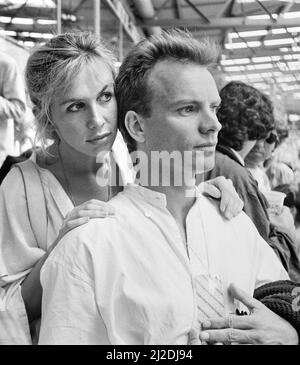 Live Aid dual venue benefit concert held on 13th July 1985 at Wembley Stadium in London, England, and the John F. Kennedy Stadium in Philadelphia, Pennsylvania, United States. The concerts were organised as a follow up to the Band Aid single 'Do They Know Its Christmas?'  to raise money for victims of the famine in Ethiopia. Picture shows Sting and his wife Trudi  watching  the concert at Wembley. Stock Photo