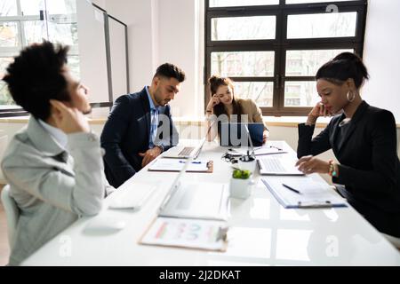 Diverse Bored Meeting Training Presentation In Office Stock Photo