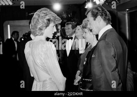 HRH The Princess of Wales, Princess Diana talking with lead actor Roger Moore at The Royal Premiere of the 14th 007 James Bond Movie, "A View To A Kill"  at the Odeon Cinema, Leicester Square, London. This was Roger Moore's last of seven Bond Films. His first "Live and Let Die", was released in 1973.  Princess Diana wears a stunning silver Bruce Oldfield dress.   In the background is actor Patrick Macnee, who plays Sir Godfrey Tibbett in the film.  Picture taken 14th June 1985 Stock Photo