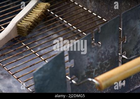 Wooden wire brush for cleaning dirty barbecue grill. Stock Photo