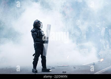 A colombia's riot police officer 'ESMAD' is seen inside a cloud of tear gas as students protested against Colombia's national police and government on March 31, 2022 in Bogota, Colombia. As demonstrators and Colombia's riot police squad 'ESMAD' ended up in clashes in northern Bogota. Photo by: Daniel Romero/Long Visual Press Stock Photo