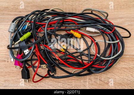 Bundle of various cables with various connectors suitable for different ports. Concept of great number of pc peripherals, equipments and connected dev Stock Photo