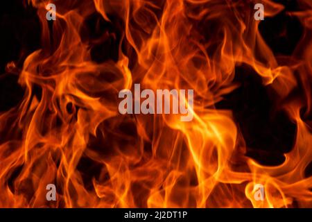 Abstract flame, fire flame texture, background. Blurred moving tongues of fire on a dark background. Stock Photo