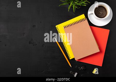 Three notepads on a black table close up Stock Photo