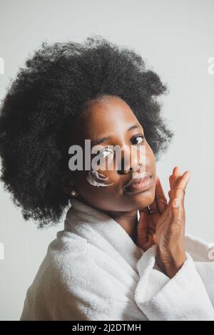 Portrait of a woman with a dab of cream on her face Stock Photo