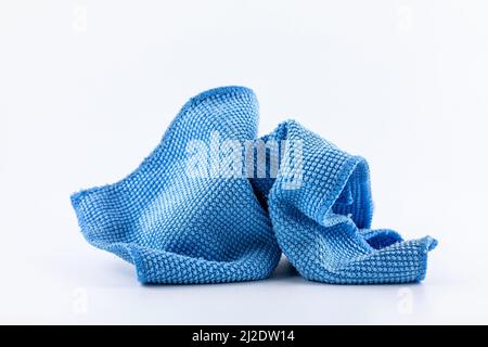 Blue microfiber fabric with rough texture for cleaning dust isolated on white background. Stock Photo