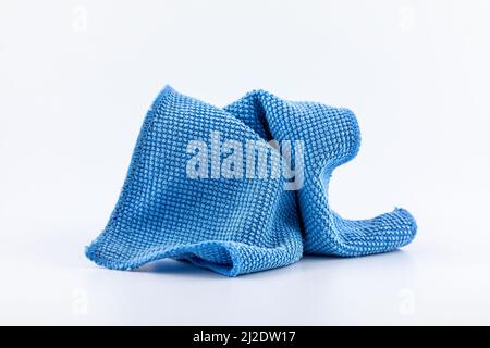 Blue microfiber fabric with rough texture for cleaning dust isolated on white background. Stock Photo