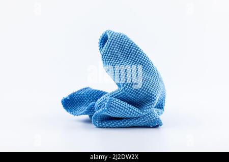 Blue microfiber fabric with rough texture for cleaning dust isolated on white background. Stock Photo