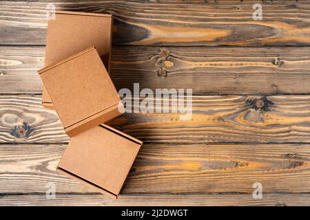 Pile of cardboard boxes on wooden background Stock Photo