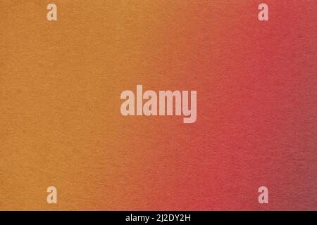 Texture of old dark red and orange colors paper background with soft gradient, macro. Structure of ginger cardboard. Abstract backdrop. Stock Photo