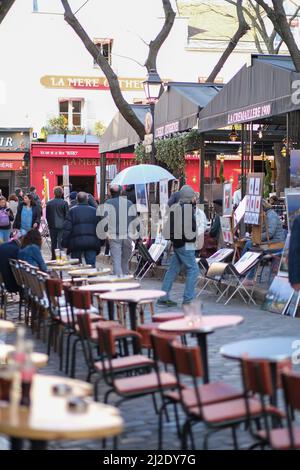 Paris, France - March 22, 2022 : Tourists enjoying drinks outdoors at the picturesque area of Montmartre Stock Photo