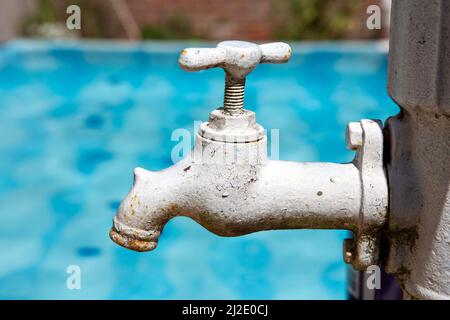 antique faucet with rust and cracked paint Stock Photo