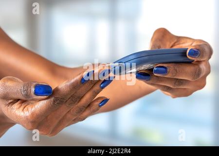 Dependent first type diabetes patient measuring glucose level blood test using ultra mini glucometer and small drop of blood from finger and test strips Stock Photo