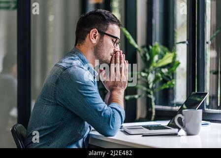 Thoughtful caucasian businessman, making sure his company prospers. Stock Photo