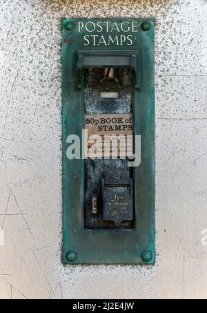 Old postage stamp coin machine no longer in use, UK Stock Photo