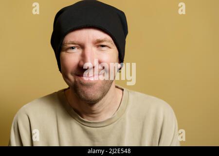 The man in the black hat rejoices. Portrait of a young man making faces Stock Photo