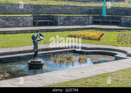 Statue of a Cherub  fountain in a pond at marine cove gardens at Burnham on sea, Somerset, United Kingdom Stock Photo