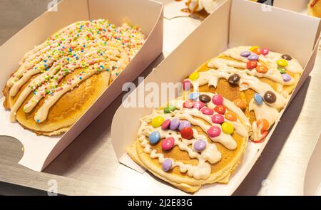 Pancakes with colorful toppings on showcase. Brussels Stock Photo