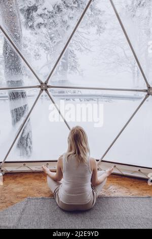 A Woman Does Yoga On The Terrace In A Geo Dome Glamping Tent