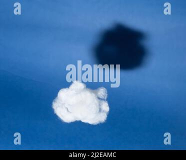 White cloud with black shadow on blue sky background. Comparison, reverse side of medal concept. Surrealism style. Hidden, invisible features. High quality photo Stock Photo