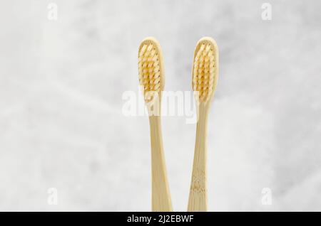 Two wooden toothbrushes on a light background. Environmentally friendly personal hygiene products. Bamboo toothbrushes Stock Photo