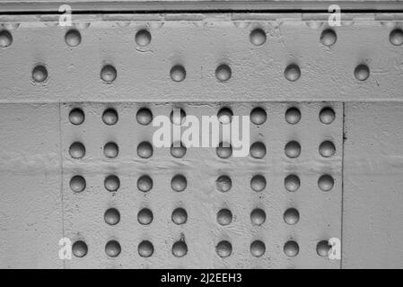 A solid structural steel bolted connection with lots of bolts and plates in black and white. Stock Photo