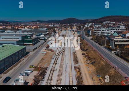 Train station of Grosuplje in Slovenia is being renovated. Visible new track layout and work trains on the tracks on a sunny day. Stock Photo