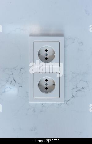 Double electrical socket on a white wall in the room Stock Photo