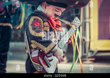 Portugal Carnival - Young boy dressed as Mexican playing the guitar -  Ovar, Grande Desfile. Big Parade, Pindéricus Grupo de Carnaval. Stock Photo