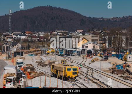 Train station of Grosuplje in Slovenia is being renovated. Visible new track layout and work trains on the tracks on a sunny day. Stock Photo