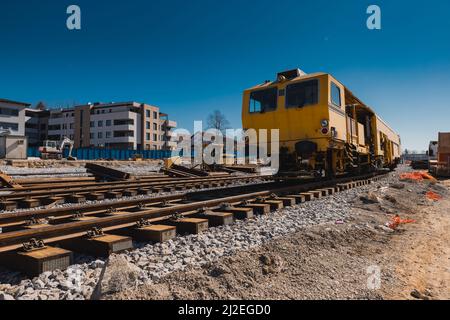 Train station of Grosuplje in Slovenia is being renovated. Visible tamper train parked on a siding on a sunny day. Stock Photo