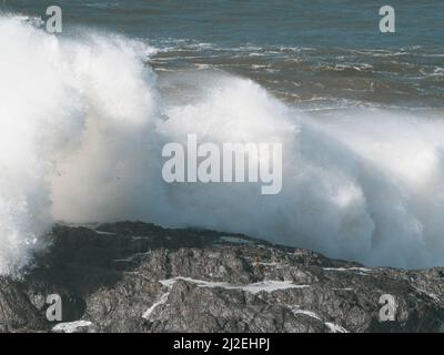 White waves, A wild sea wave crashing and smashing over rocks at the headland, powerful force of nature on display, Pacific Ocean, NSW, Australia Stock Photo