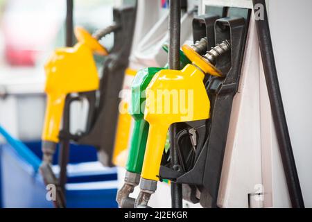 Petrol pump filling nozzles at the gas station in a service Stock Photo