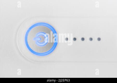 Power switch button with blue led light, close up. Technology concept. High quality photo Stock Photo
