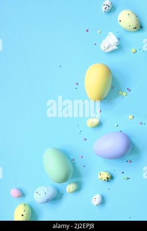 Easter composition. Easter eggs and easter bunny on pastel blue background. Minimal concept of Easter. Flat lay, top view, copy space Stock Photo