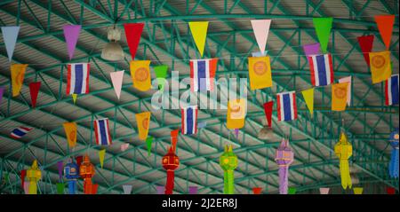 Many multicolored triangular flags adorn the blurred garden. , postcard background, Valentine's Day Stock Photo