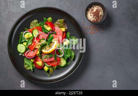 Salad with salmon, vegetables, fresh herbs and sesame and flax seeds. Stock Photo