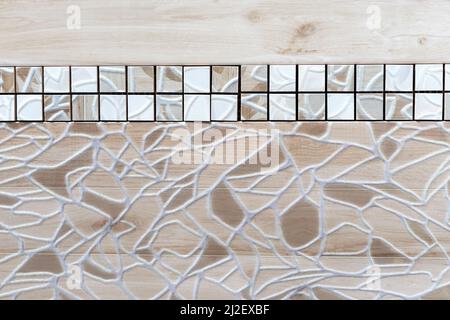 Beige-brown ceramic tile with abstract pattern and border. Stock Photo