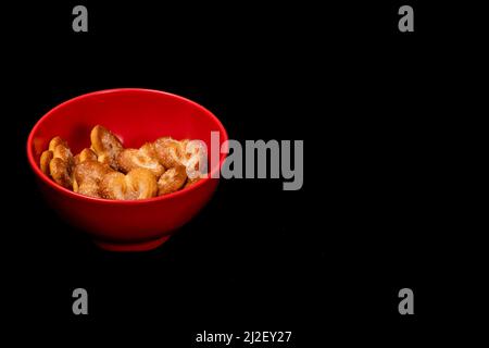 Hearts Shaped Biscuit In Red Round Bowl, Biscuits Heap Copy Space, Isolated On Black Background Stock Photo